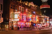 Downtown Nashville street with neon lights and signs.